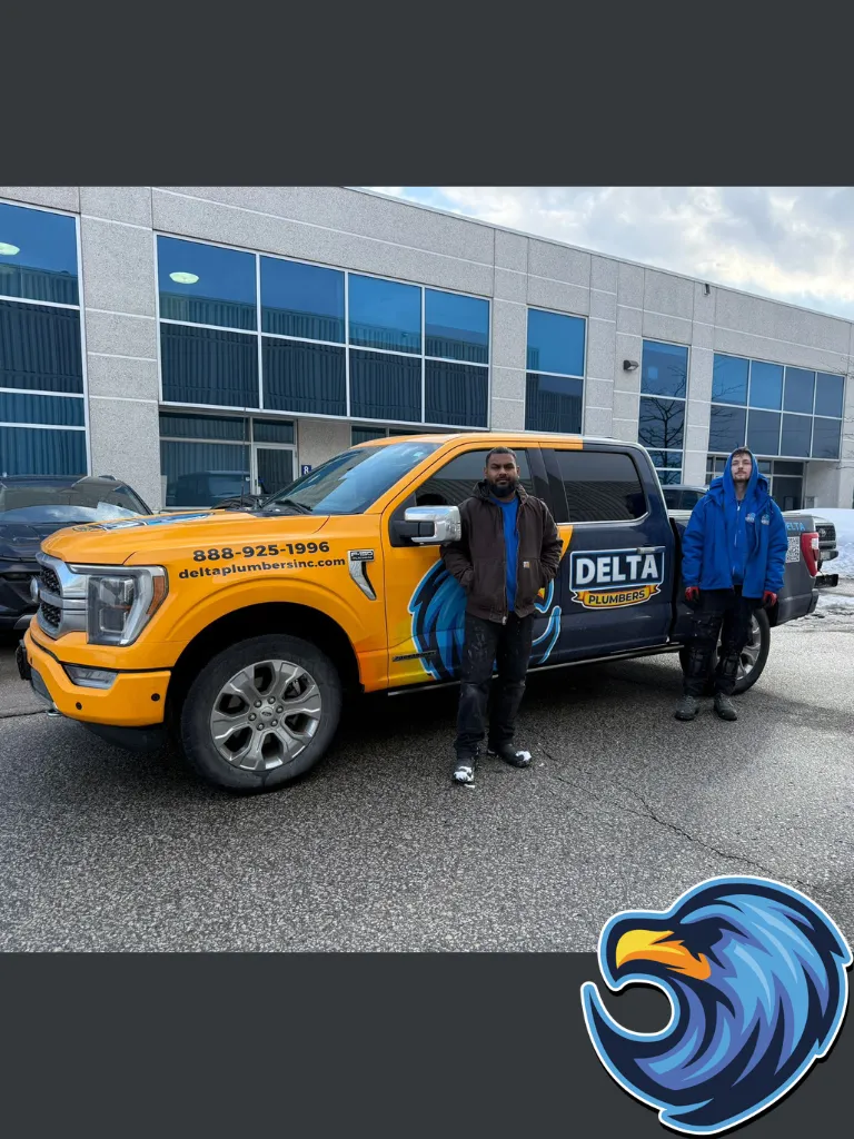 Delta Plumbers Standing infront of the plumbing truck in Hamilton - Delta Plumbers